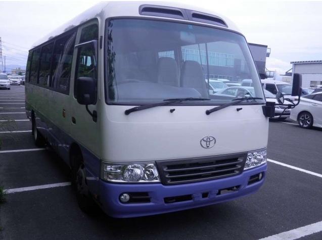 Used Toyota Coaster Bus photo: 2014 model White and Lavender Two Tone color - Front view
